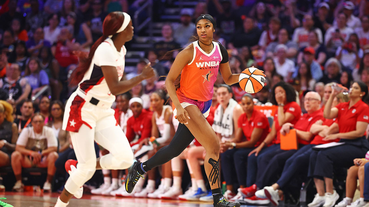 Team WNBA forward Angel Reese (5) drives to the basket during the first half as USA Women's National Team guard Kahleah Copper (7) defends at Footprint Center. 