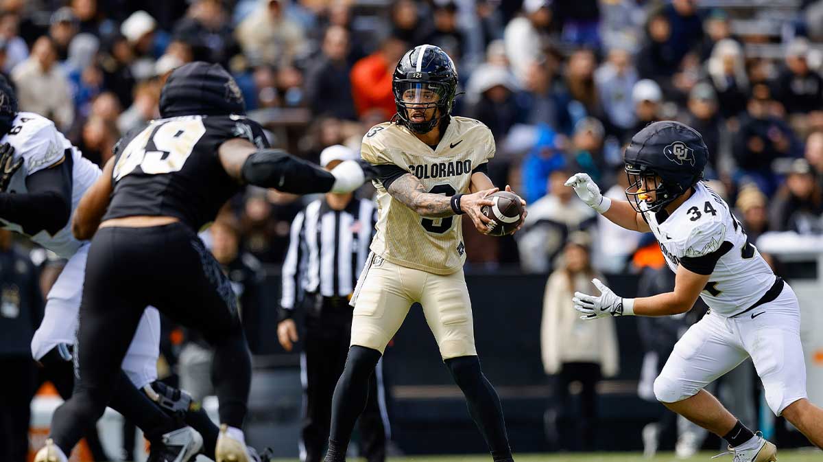 Colorado Buffaloes quarterback Kaidon Salter (3) hands the ball off to running back Titus Bautista (34) as defensive end Quency Wiggins (49) defends during the spring game at Folsom Field.