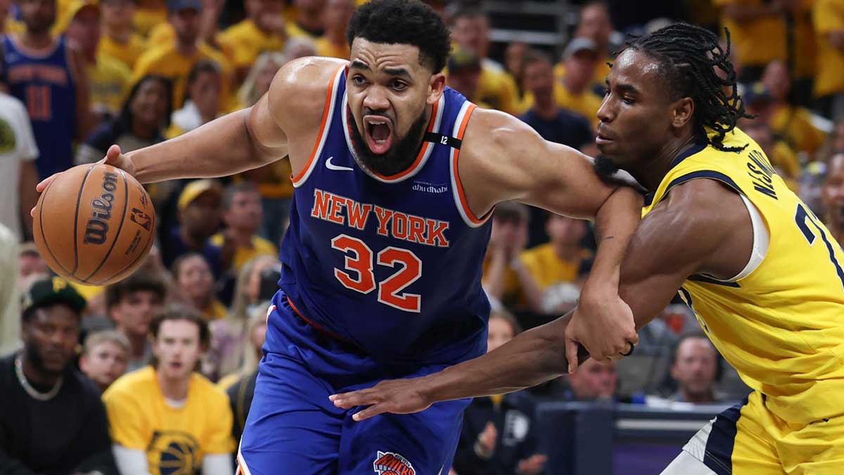 New York Knicks center Karl-Anthony Towns (32) drives to the basket against Indiana Pacers guard Andrew Nembhard (2) in the third quarter during game six of the eastern conference finals for the 2025 NBA Playoffs at Gainbridge Fieldhouse.