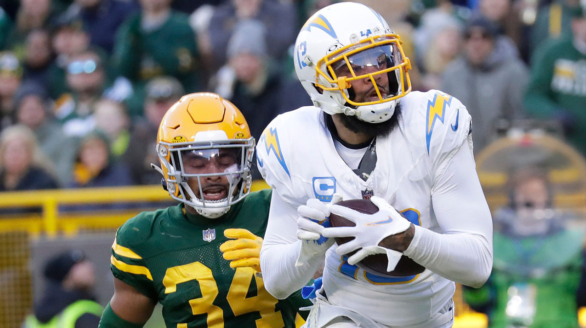 Los Angeles Chargers wide receiver Keenan Allen (13) scores a touchdown against Green Bay Packers safety Jonathan Owens (34) during their football game Sunday, November 19, 2023, at Lambeau Field in Green Bay, Wis.