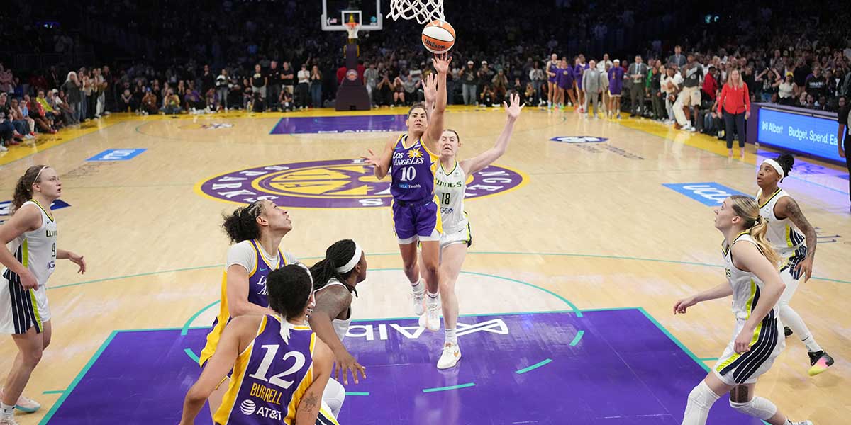 LA Sparks guard Kelsey Plum (10) scores with no time remaining against Dallas Wings center Luisa Geiselsoder (18) for the game-winning basket at Crypto.com Arena.