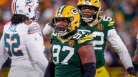 Green Bay Packers defensive tackle Kenny Clark (97) and defensive end Rashan Gary (52) celebrate after Clark sacks Miami Dolphins quarterback Tua Tagovailoa on Thursday, November 28, 2024, at Lambeau Field in Green Bay, Wis. The Packers won the game, 30-17.