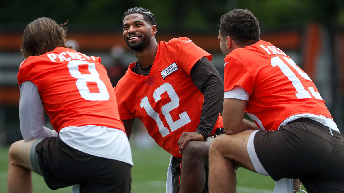 Browns quarterbacks Shedeur Sanders (12), Kenny Pickett (8) and Joe Flacco (15) talk during minicamp in Berea, Ohio.