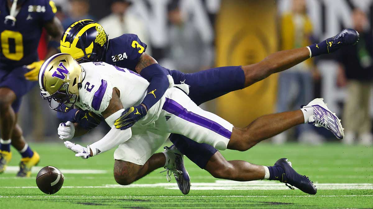 Washington Huskies wide receiver Ja'Lynn Polk (2) is unable to make a catch while defended by Michigan Wolverines defensive back Keon Sabb (3) during the fourth quarter in the 2024 College Football Playoff national championship game at NRG Stadium.