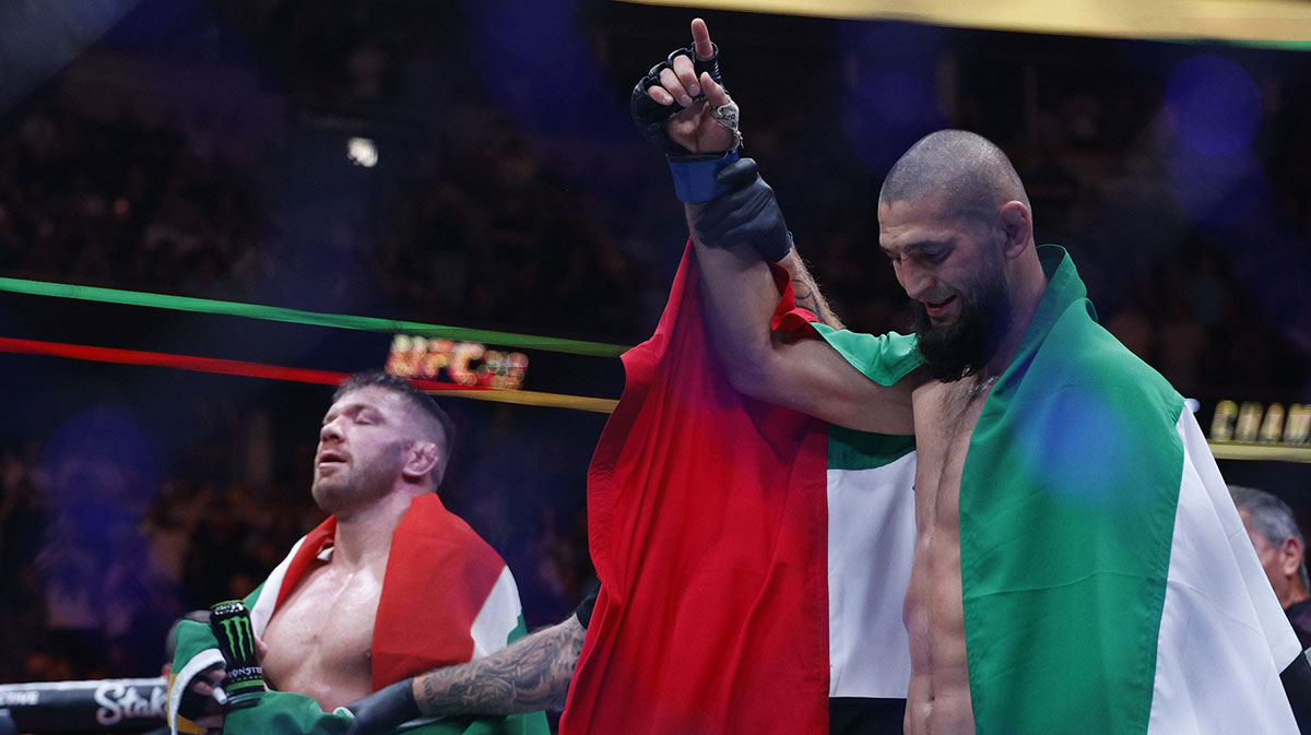 Khamzat Chimaev (blue gloves) reacts after the fight against Dricus Du Plessis Murphy (red gloves) during UFC 319 at United Center.