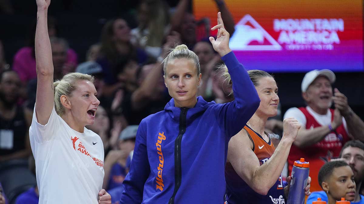 Mercury guards Lexie Held (center white) and Kitija Laska (center purple) celebrate a basket at PHX Arena in Phoenix on Aug. 7, 2025.