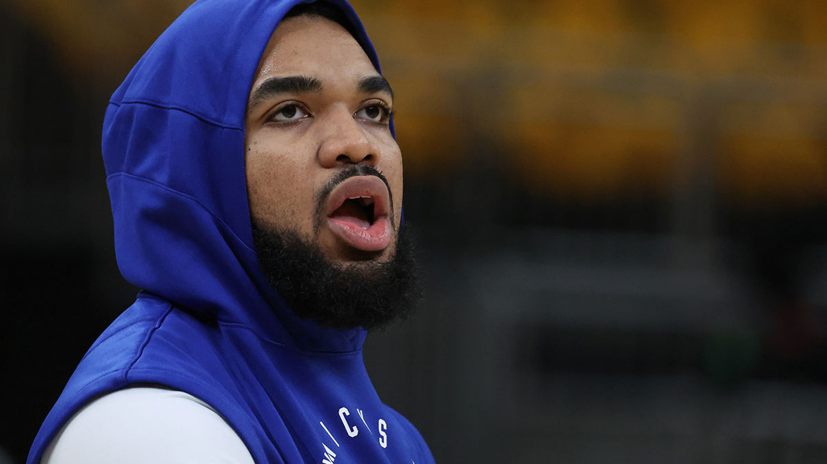 Knicks center Karl-Anthony Towns (32) looks on during warmups prior to game six of the eastern conference finals against the Indiana Pacers for the 2025 NBA Playoffs at Gainbridge Fieldhouse with Suns' Devin Booker in the background