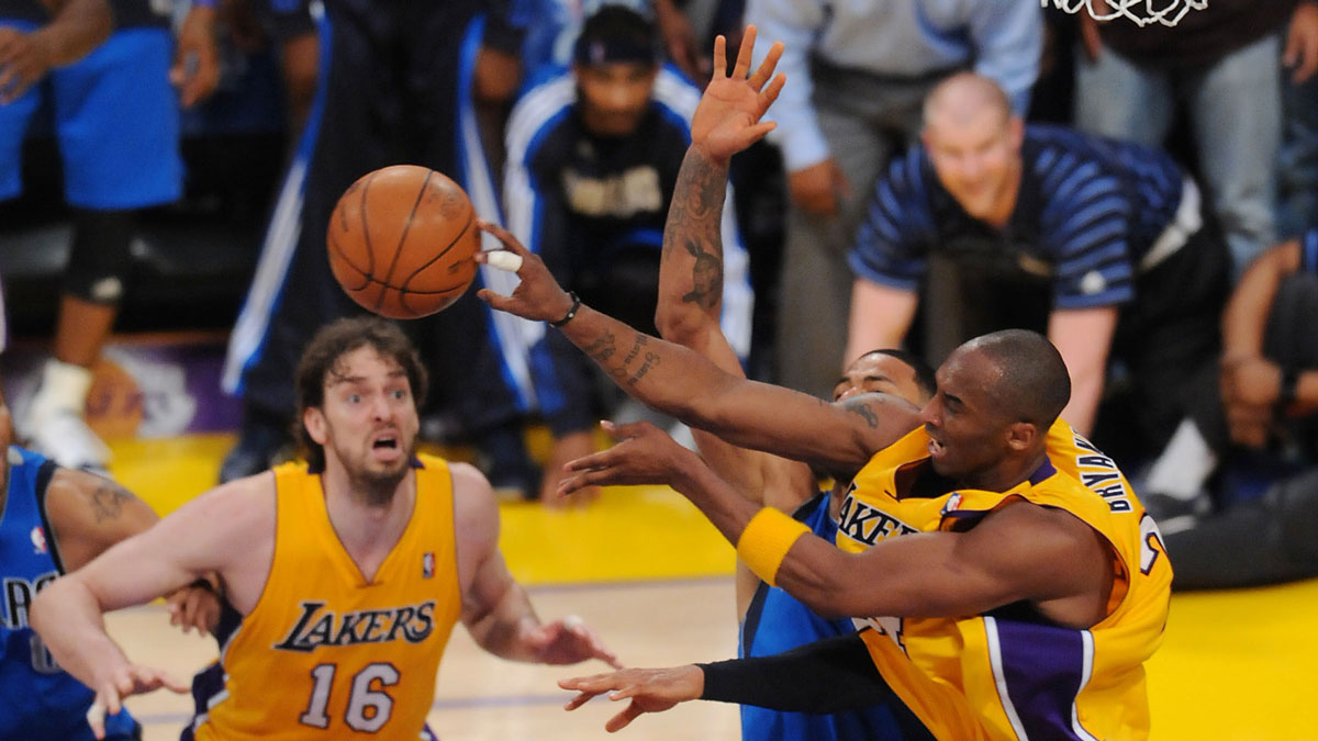 Los Angeles Lakers power forward Pau Gasol (16) looks on as shooting guard Kobe Bryant (24) passes the ball by Dallas Mavericks center Tyson Chandler (6) in the 4th quarter of game one of the second round of the 2011 NBA playoffs at the Staples Center. Mavericks won 96-94.