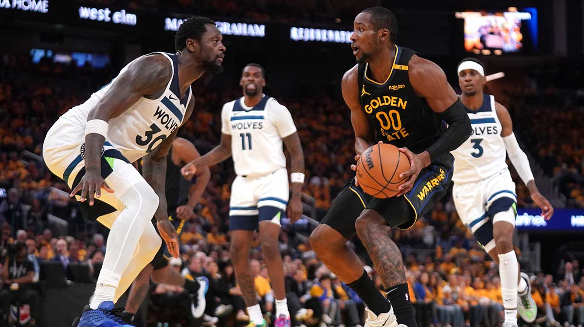 Golden State Warriors forward Jonathan Kuminga (00) holds onto the ball next to Minnesota Timberwolves forward Julius Randle (30) in the third quarter during game four of the second round for the 2025 NBA Playoffs at Chase Center.