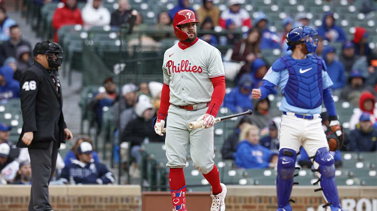 Philadelphia Phillies designated hitter Kyle Schwarber (12) walks back to the dugout after striking out against the Chicago Cubs during the eighth inning at Wrigley Field.