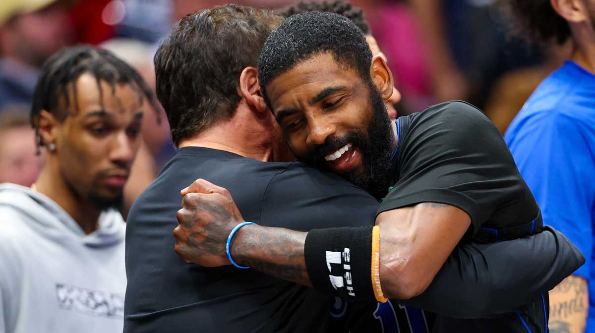 Dallas Mavericks guard Kyrie Irving (11) celebrates with Mark Cuban during the second half against the Phoenix Suns at American Airlines Center.