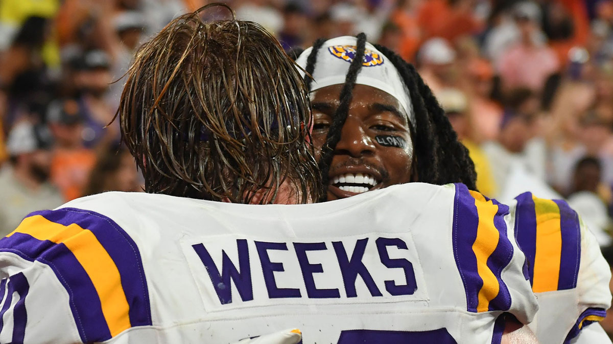 LSU Tigers linebacker Whit Weeks (40) hugs LSU Tigers linebacker Harold Perkins Jr. (7).