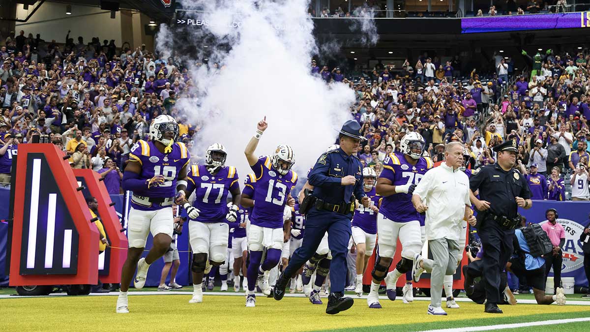 LSU Tigers head coach Brian Kelly and the LSU tigers run out on the field before playing against the Baylor Bears at NRG Stadium.