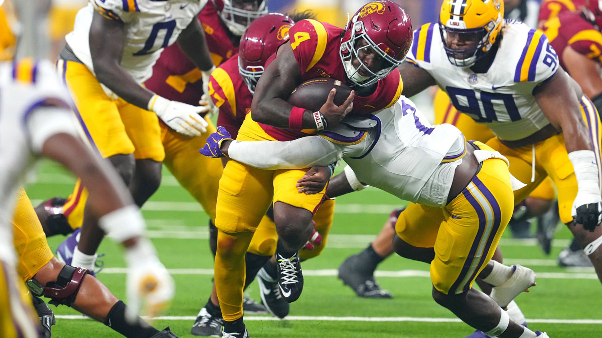 Southern California Trojans running back Woody Marks (4) is tackled by LSU Tigers linebacker Harold Perkins Jr. (7) during the second quarter at Allegiant Stadium.
