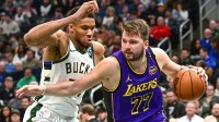 Los Angeles Lakers guard Luka Doncic (77) drives to the basket against Milwaukee Bucks forward Giannis Antetokounmpo (34) in the third quarter at Fiserv Forum.