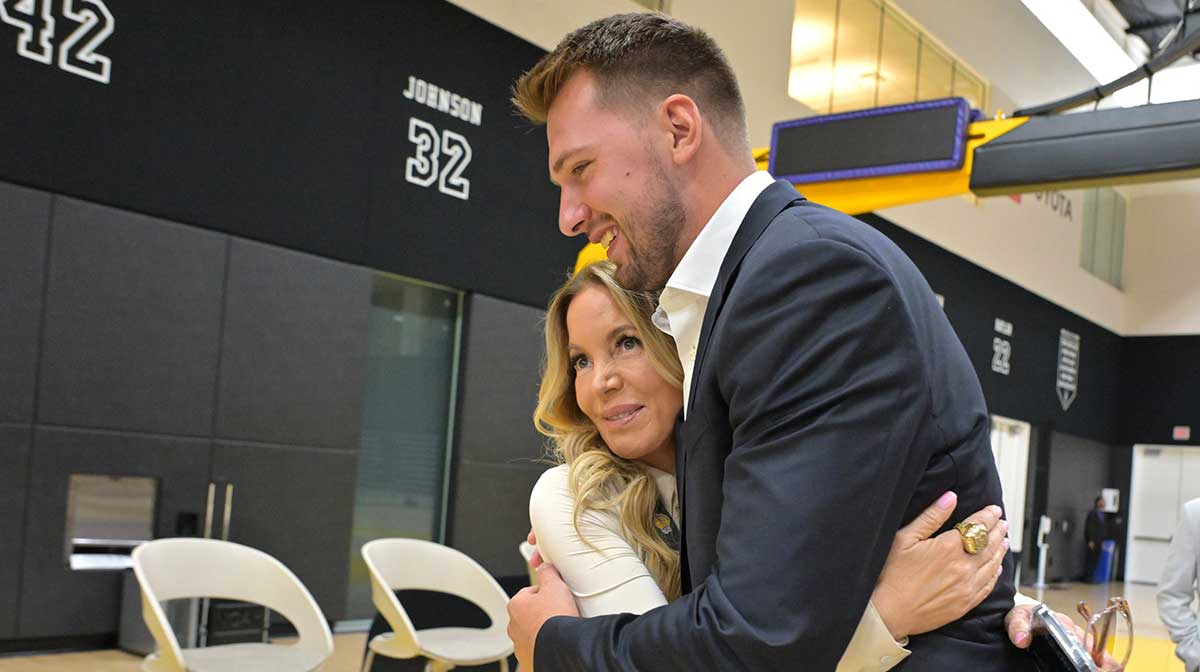 Lakers Luka Doncic (77) gets a hug from team co-owner Jeanie Buss following a press conference announcing the signing of his contract extension at UCLA Health Training Center