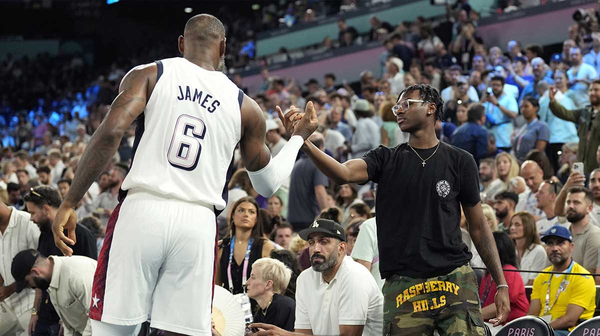 Lakers' LeBron James (6) shakes hands with son Bryce James against Serbia in a men's basketball semifinal game during the Paris 2024 Olympic Summer Games at Accor Arena