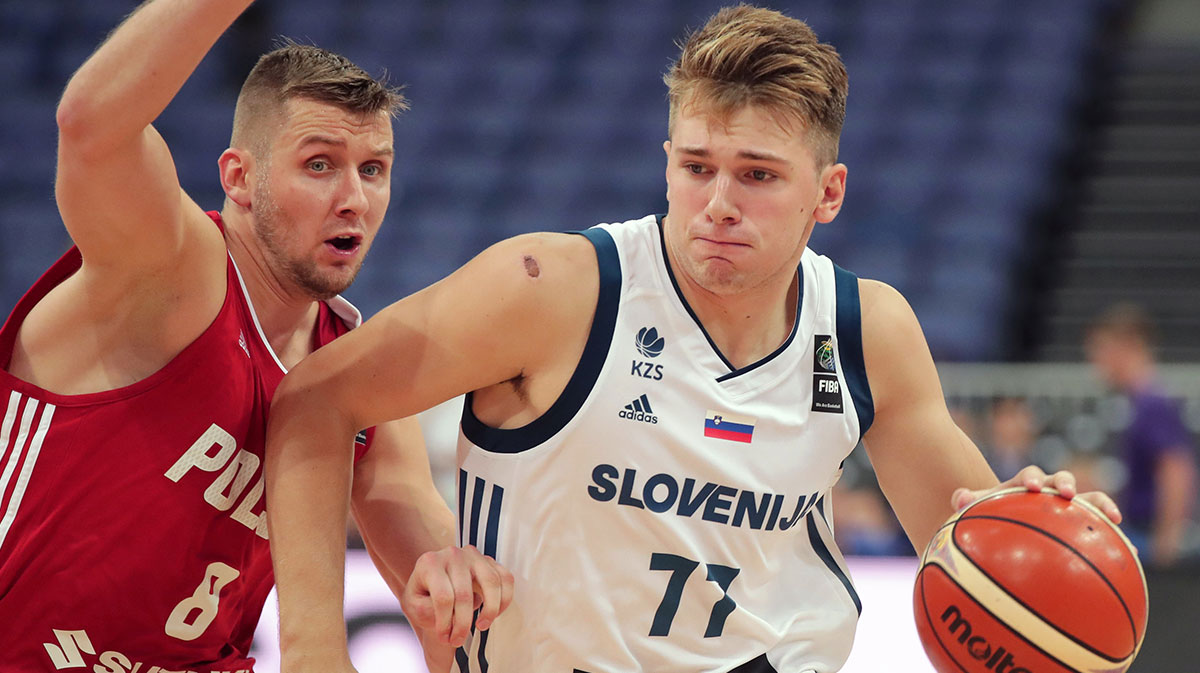 Poland player Przemyslaw Zamojski (8) defends against Slovenia player Luka Doncic (77) during their FIBA Eurobasket Group A match in Helsinki Arena 31.