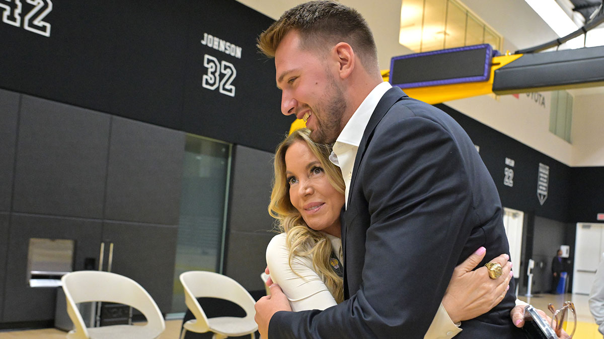 Lakers Luka Doncic (77) gets a hug from team co-owner Jeanie Buss following a press conference announcing the signing of his contract extension at UCLA Health Training Center