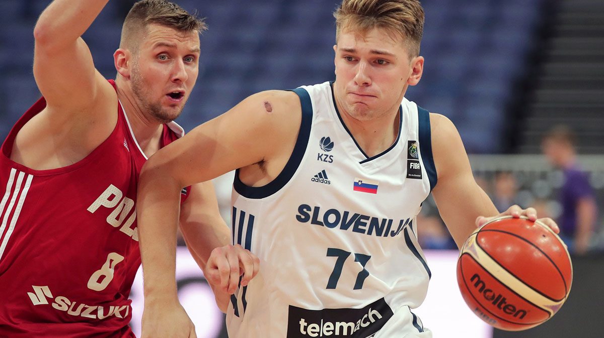 Poland player Przemyslaw Zamojski (8) defends against Slovenia player Luka Doncic (77) during their FIBA Eurobasket Group A match in Helsinki Arena 31.