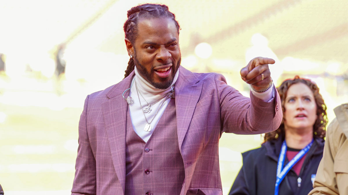 Commentator Richard Sherman signals to fans prior to a game between the Kansas City Chiefs and Las Vegas Raiders at GEHA Field at Arrowhead Stadium.