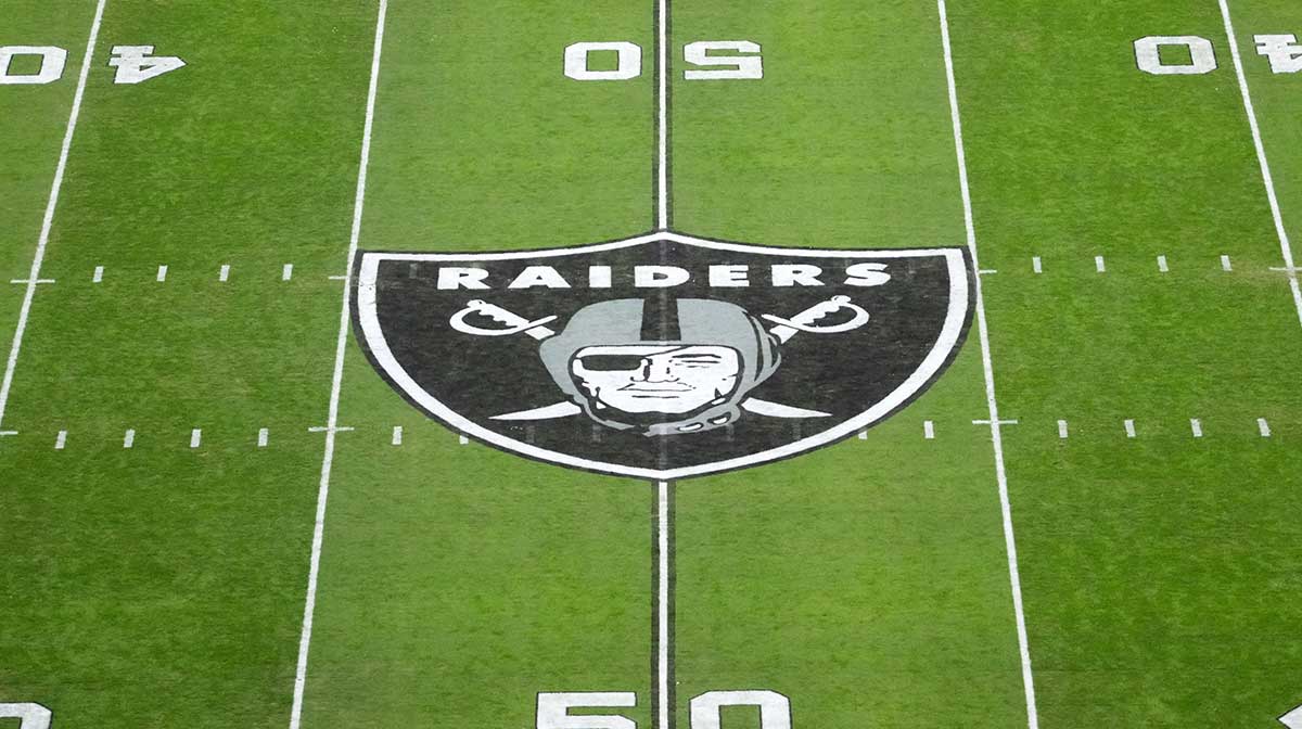 The Las Vegas Raiders shield logo at midfield at Allegiant Stadium.