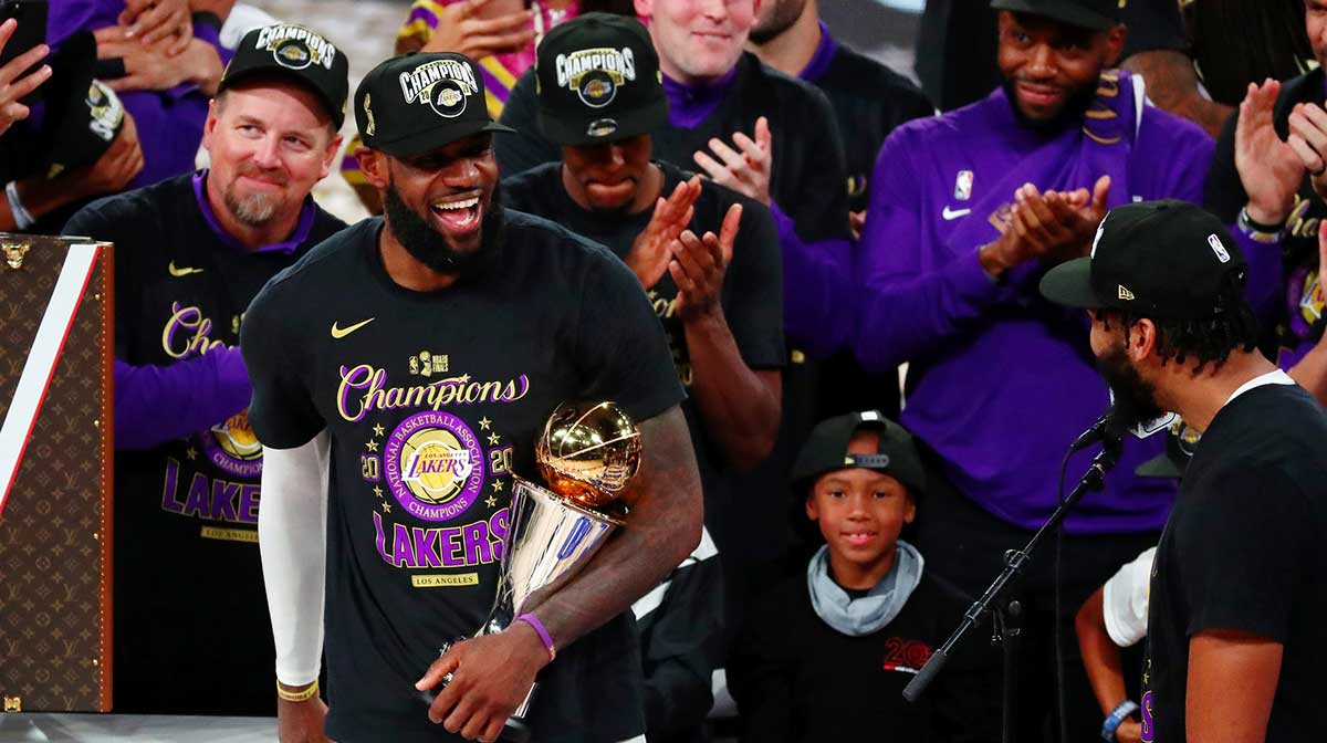Los Angeles Lakers forward LeBron James (23) smiles at forward Anthony Davis (3) while holding the MVP trophy after game six of the 2020 NBA Finals at AdventHealth Arena. The Los Angeles Lakers won 106-93 to win the series.