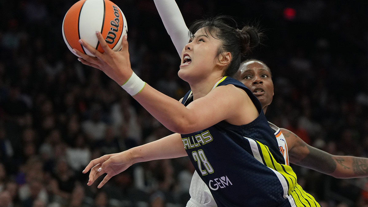 Dallas Wings center Li Yueru (28) drives on Phoenix Mercury forward Natasha Mack (4) in the first half at Footprint Center.