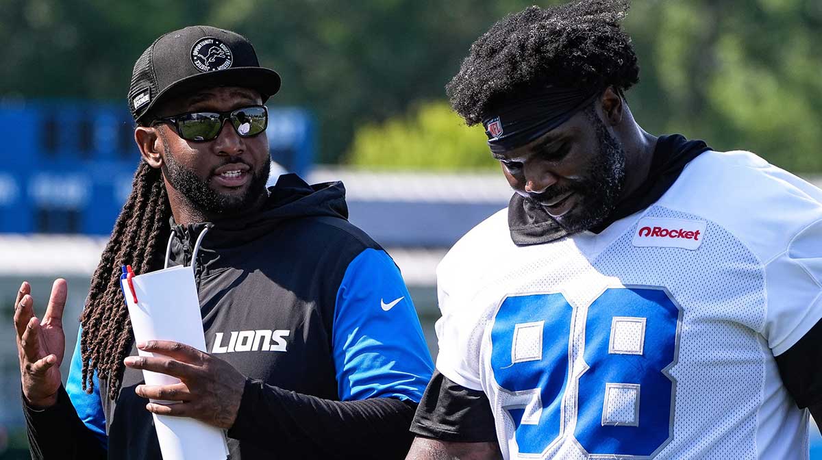 Detroit Lions defensive coordinator Kelvin Sheppard, left, talks to defensive tackle DJ Reader (98) as they walks off the field after practice during training camp at Meijer Performance Center in Allen Park on Monday, July 21, 2025.
