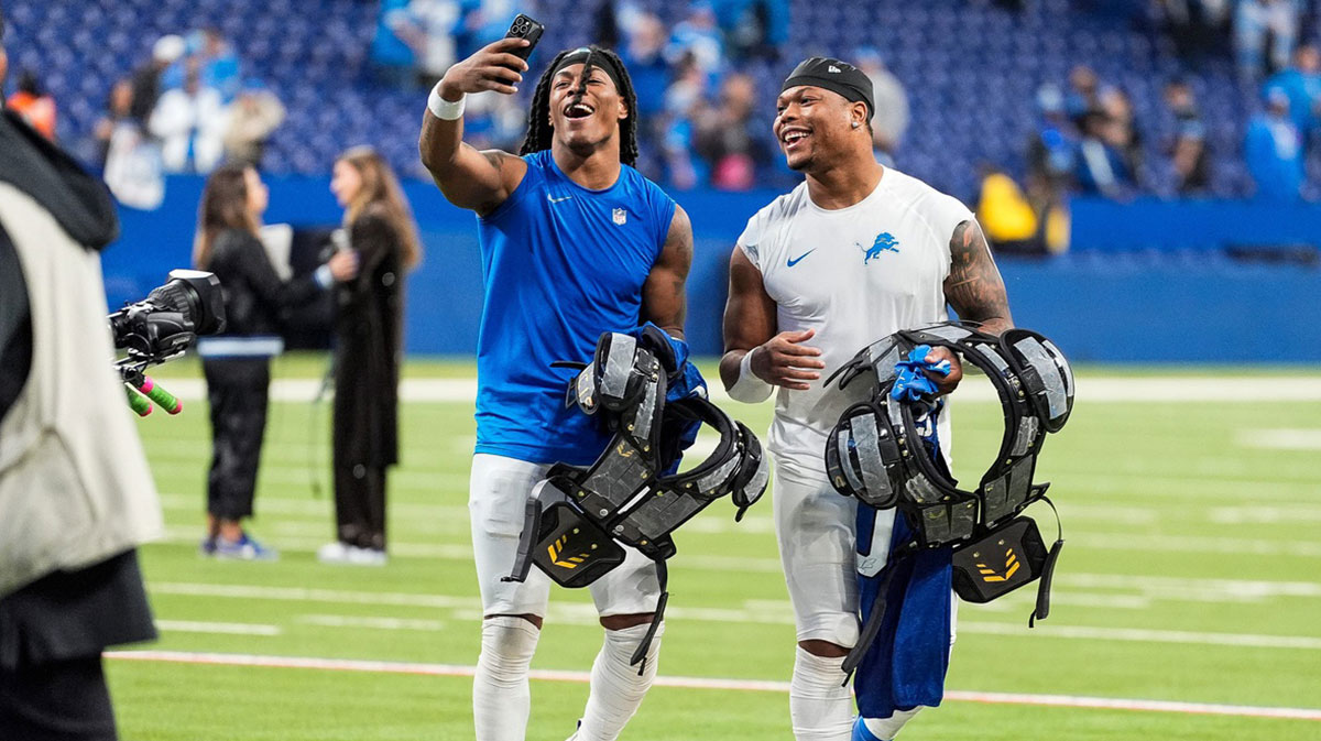 Detroit Lions running back Jahmyr Gibbs (26), left, and running back David Montgomery (5) record a video to celebrate 24-6 win over Indianapolis Colts at Lucas Oil Stadium in Indianapolis, Ind. on Sunday, Nov. 24, 2024.