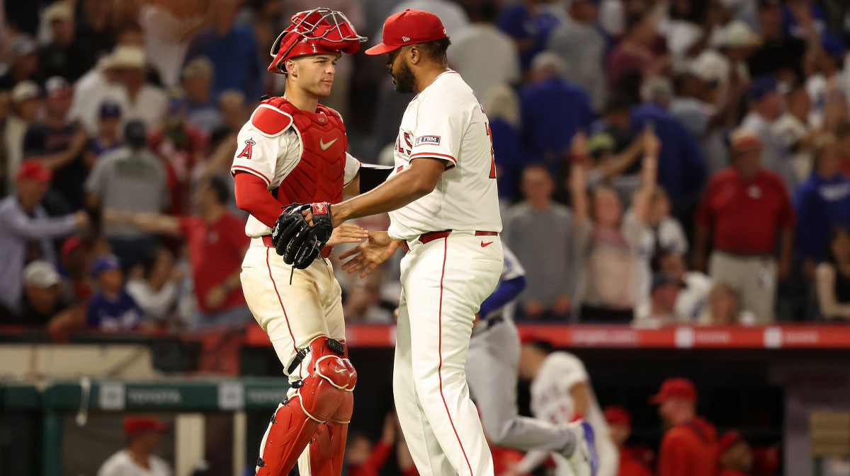 Los Angeles Angels catcher Logan O'Hoppe (14) and relief pitcher Kenley Jansen (74) celebrate a win after defeating the Los Angeles Dodgers 6-5 at Angel Stadium.