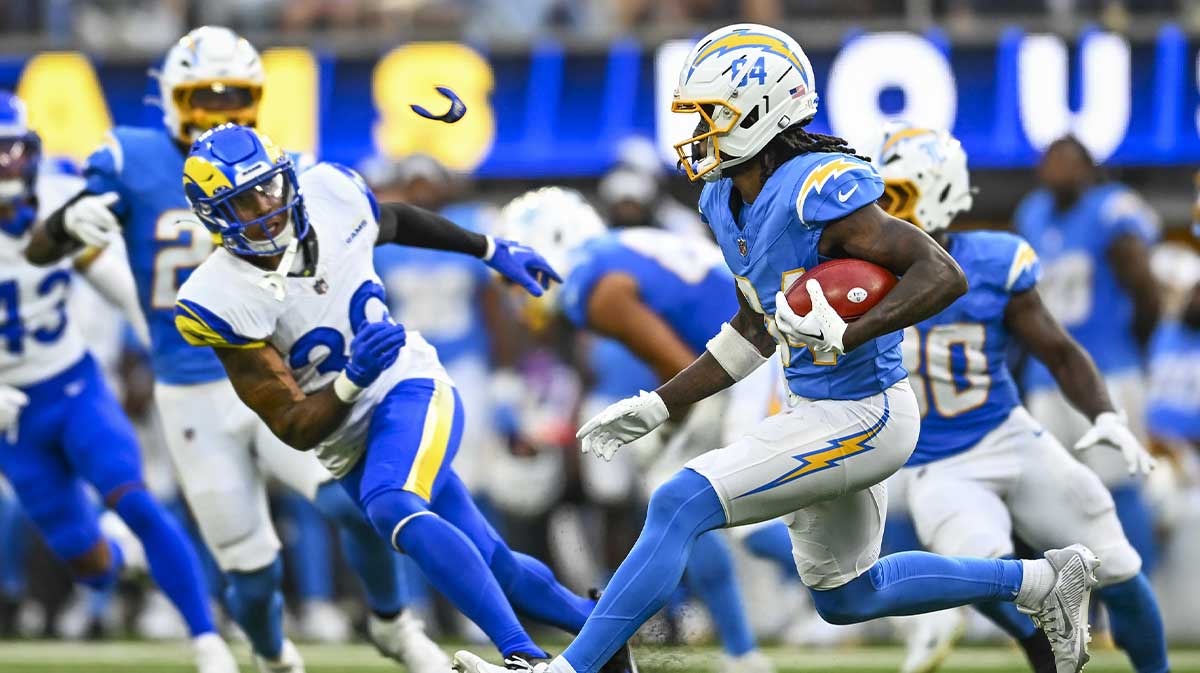 Los Angeles Chargers wide receiver KeAndre Lambert-Smith (84) runs the ball against Los Angeles Rams safety Malik Dixon-Williams (39) during the second quarter at SoFi Stadium.