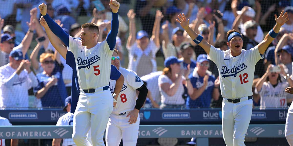 Los Angeles Dodgers first baseman Freddie Freeman (5), left fielder Enrique Hernandez (8) and right fielder Alex Call (12) celebrate after catcher Will Smith (16) hit a walk-off home run in the ninth inning against the Arizona Diamondbacks at Dodger Stadium.