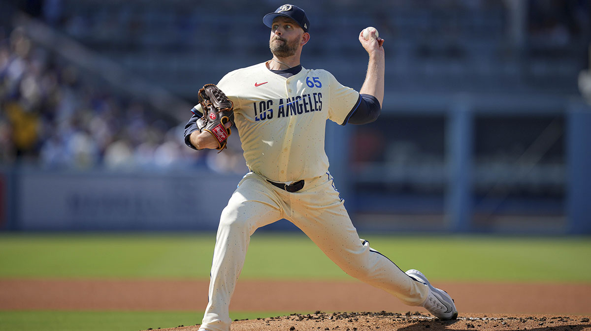 Los Angeles Dodgers hitting coach Aaron Bates (65) throws against the Milwaukee Brewers at Dodger Stadium.