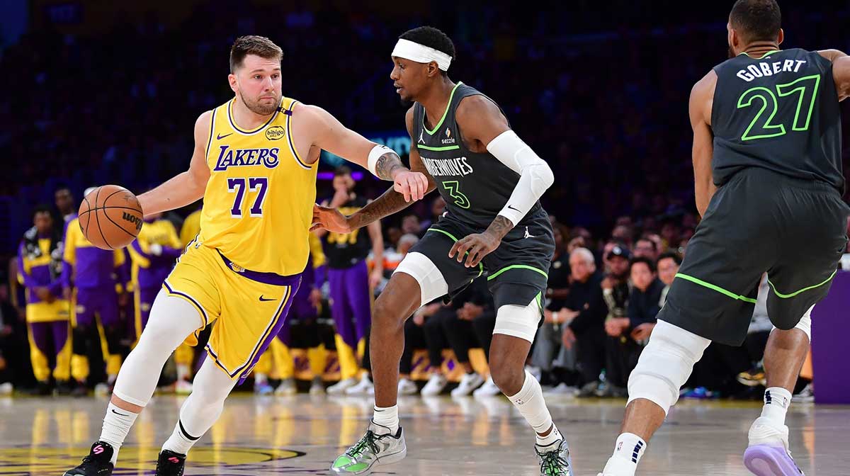 Los Angeles Lakers guard Luka Doncic (77) moves the ball against Minnesota Timberwolves forward Jaden McDaniels (3) during the first half in game five of first round for the 2025 NBA Playoffs at Crypto.com Arena.
