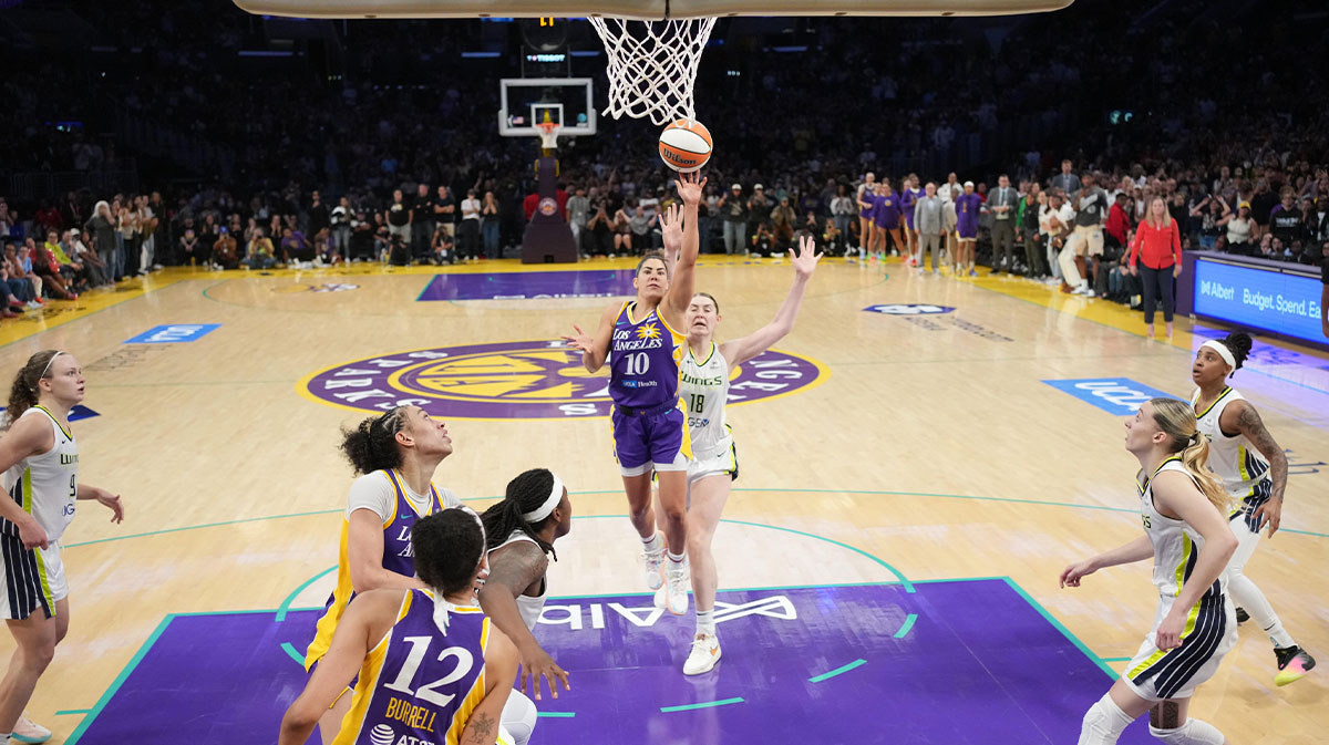 LA Sparks guard Kelsey Plum (10) scores with no time remaining against Dallas Wings center Luisa Geiselsoder (18) for the game-winning basket at Crypto.com Arena.