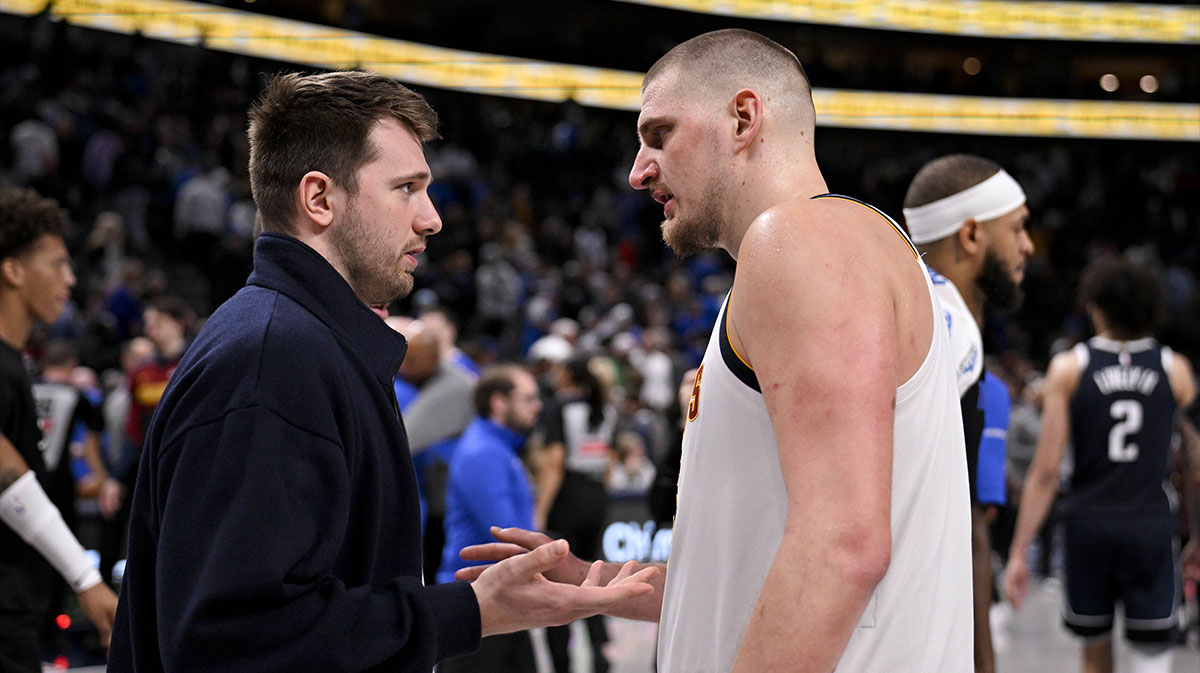Dallas Mavericks guard Luka Doncic (left) talks with Denver Nuggets center Nikola Jokic (right) after the game at the American Airlines Center.