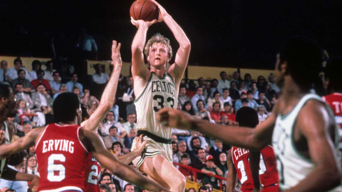 Boston Celtics forward Larry Bird (33) shoots over Philadelphia 76ers forward Julius Erving (back) battle for position at the Boston Garden.
