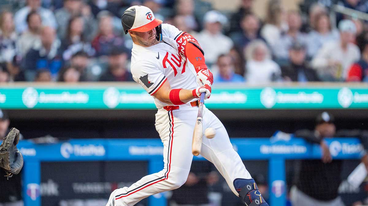 Apr 23, 2025; Minneapolis, Minnesota, USA; Minnesota Twins first base Ty France (13) singles off Chicago White Sox starting pitcher Bryse Wilson (46) and scoring Minnesota Twins second base Luke Keaschall (15) in the third inning at Target Field.