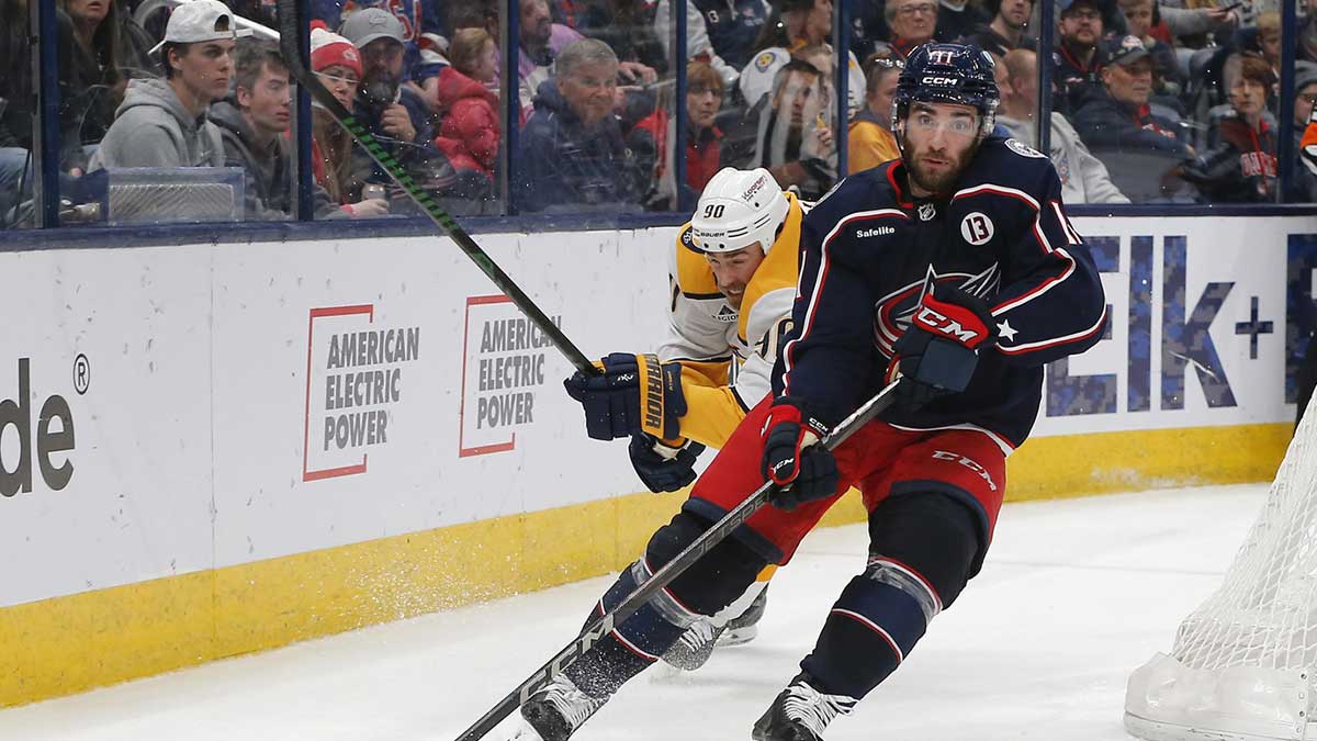 Columbus Blue Jackets center Luke Kunin (11) controls the puck as Nashville Predators center Ryan O'Reilly (90) trails the play during the third period at Nationwide Arena.