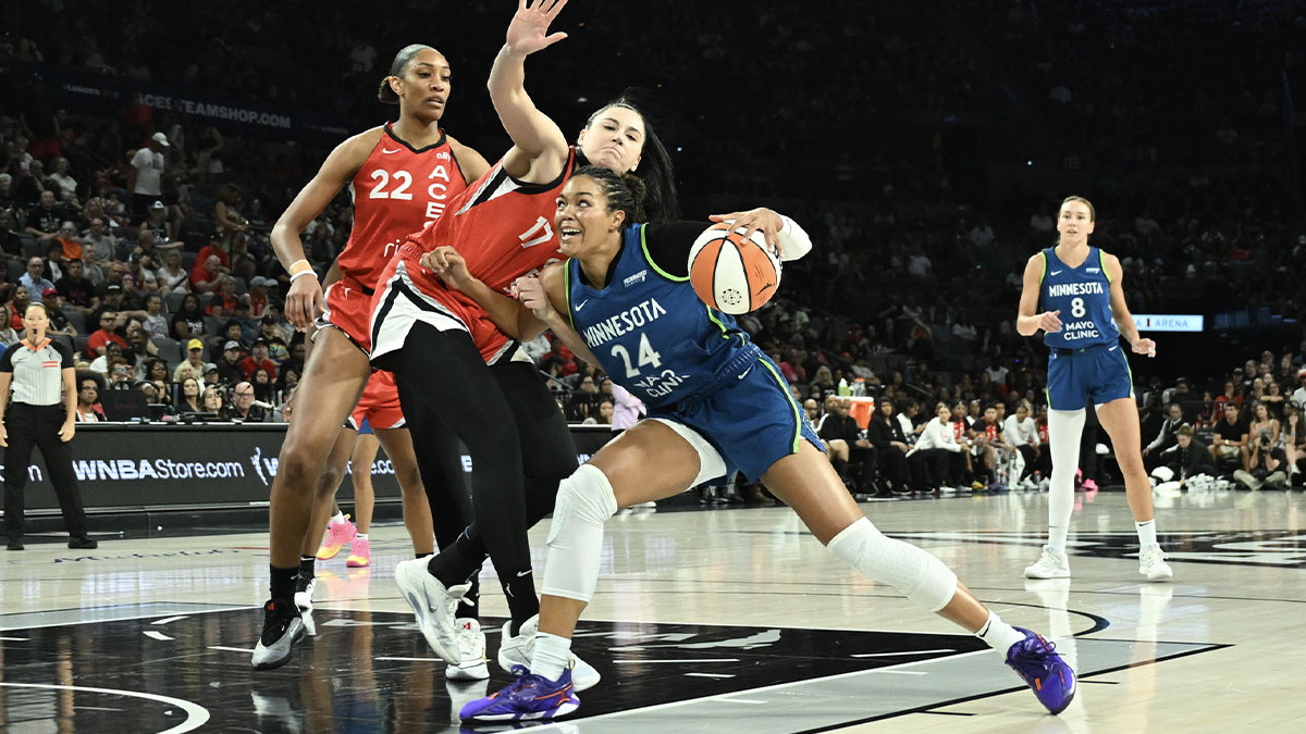 Minnesota Lynx forward Napheesa Collier drives against Las Vegas Aces center Megan Gustafson during the first quarter of their game at Michelob Ultra Arena.