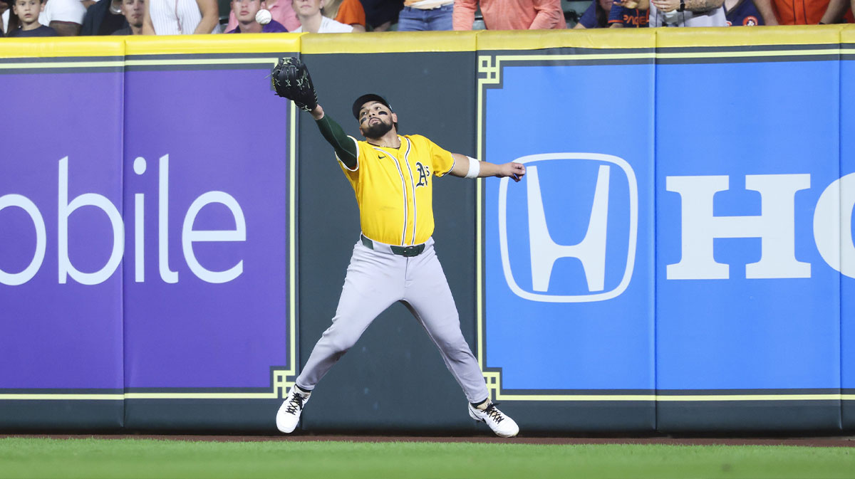 Athletics right fielder Carlos Cortes (26) attempts to play a ball off the wall during the seventh inning against the Houston Astros at Daikin Park.