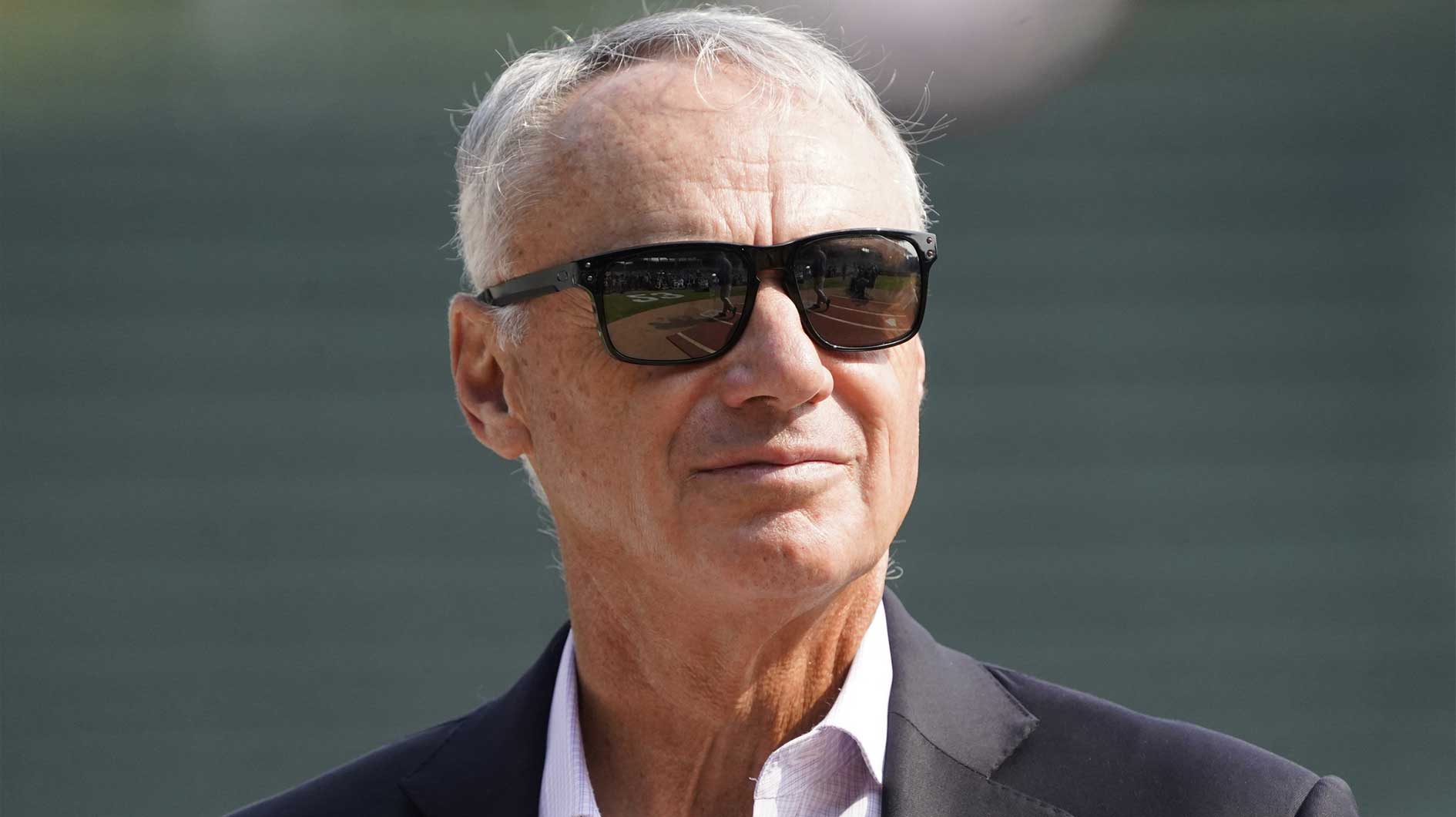 Baseball commissioner Rob Manfred announces Major League Baseball and the Chicago Cubs will host the 2027 All Star game at Wrigley Field with Phillies' Bryce Harper in the background