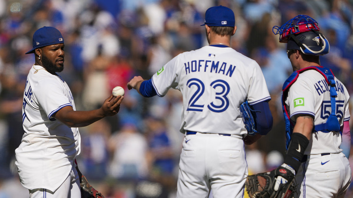 Toronto Blue Jays first base Vladimir Guerrero Jr. (27) gives pitcher Jeff Hoffman (23) a ball after defeating the Milwaukee Brewers at Rogers Centre.