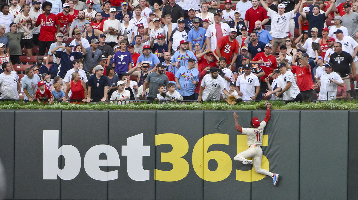 St. Louis Cardinals center fielder Victor Scott II (11) leaps and smashes into the wall but is unable to catch a solo home run hit by New York Yankees designated hitter Aaron Judge (not pictured) during the third inning at Busch Stadium.