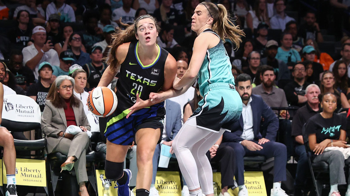 Dallas Wings forward Maddy Siegrist (20) looks to drive past New York Liberty guard Sabrina Ionescu (20) in the second quarter at Barclays Center.