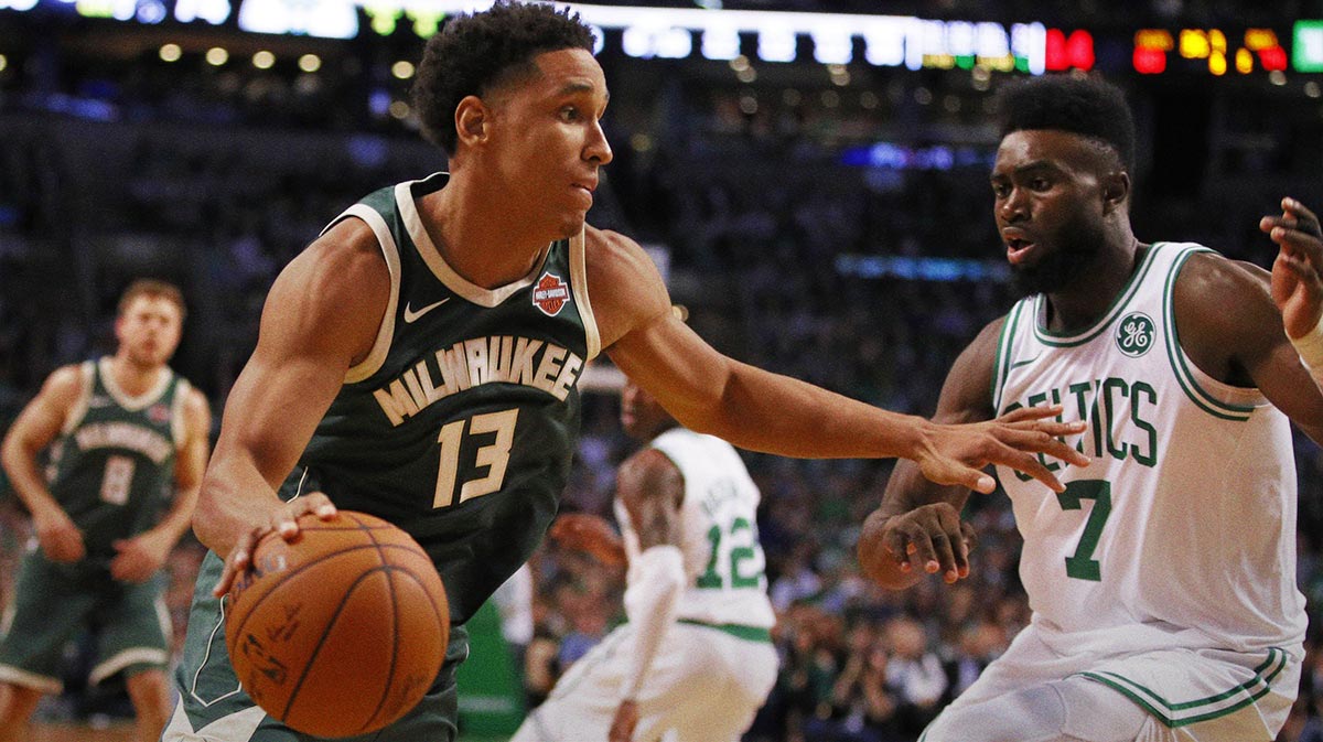 Milwaukee Bucks guard Malcolm Brogdon (13) drives the ball against Boston Celtics forward Jaylen Brown (7) in the third quarter at TD Garden.