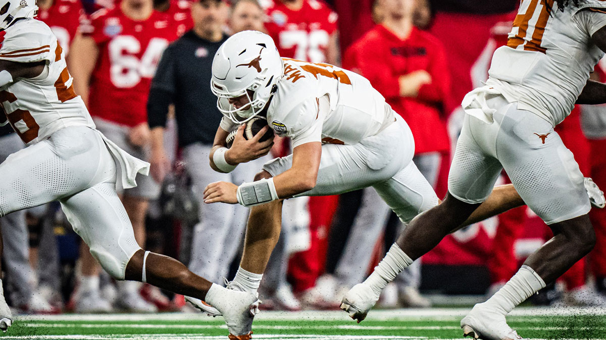 Texas Longhorns quarterback Arch Manning (16) carries the ball for a first down in the second quarter as the Texas Longhorns play the Ohio State Buckeyes in the Cotton Bowl College Football Playoff semi-final at AT&T Stadium in Dallas, Texas