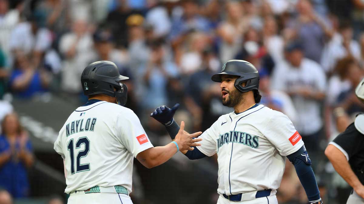 Seattle Mariners first baseman Josh Naylor (12) and third baseman Eugenio Suarez (28) celebrate after Suarez hit a 2-run home run against the Chicago White Sox during the fourth inning at T-Mobile Park.