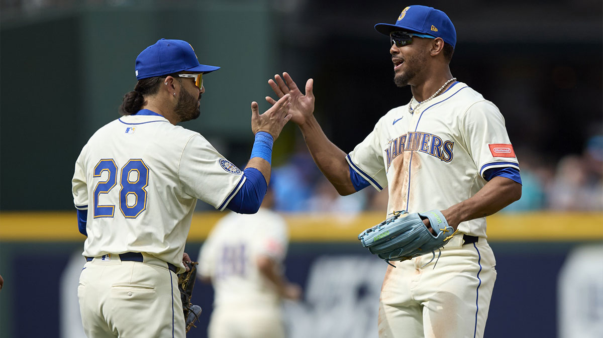 Seattle Mariners third baseman Eugenio Suarez (28) greets Seattle Mariners center fielder Julio Rodríguez (44) after playing the Texas Rangers at T-Mobile Park. Mariners MLB Trade Deadline haul earns praise from Jeff Passan. Seattle lands Eugenio Suarez, boosts roster, and keeps top prospects intact.